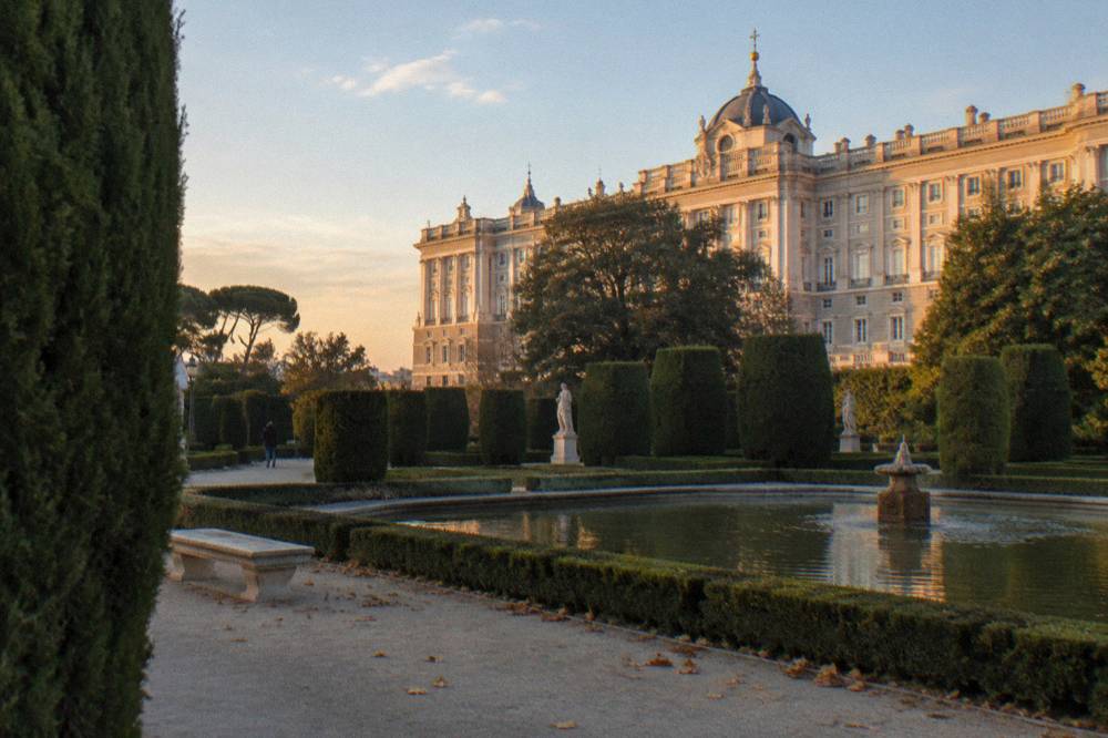 The Royal Palace of Madrid seen from the gardens in late afternoon light