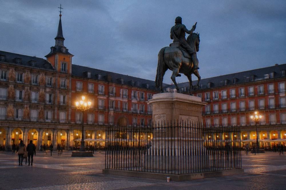 The statue of Felipe III in Plaza Mayor under evening light