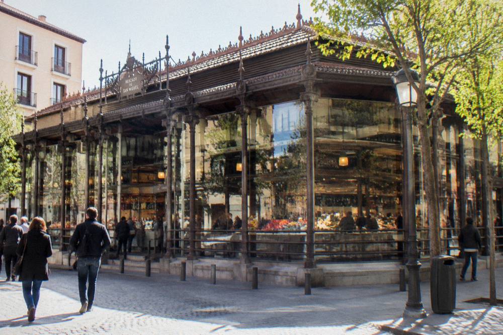 Outdoor terrace tables with coffee cups on a sunny Madrid street