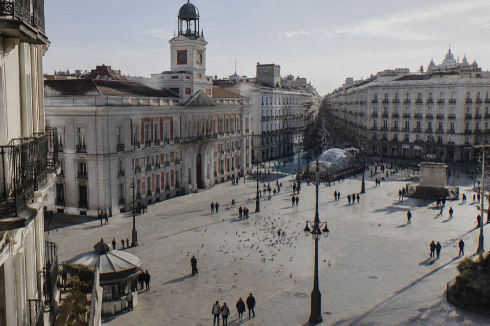 An open plaza in central Madrid with historic buildings under a clear sky