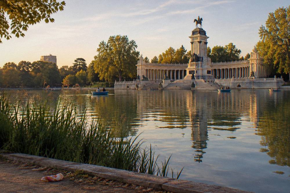 Monument to Alfonso XII with its colonnade reflected in the lake at Retiro Park