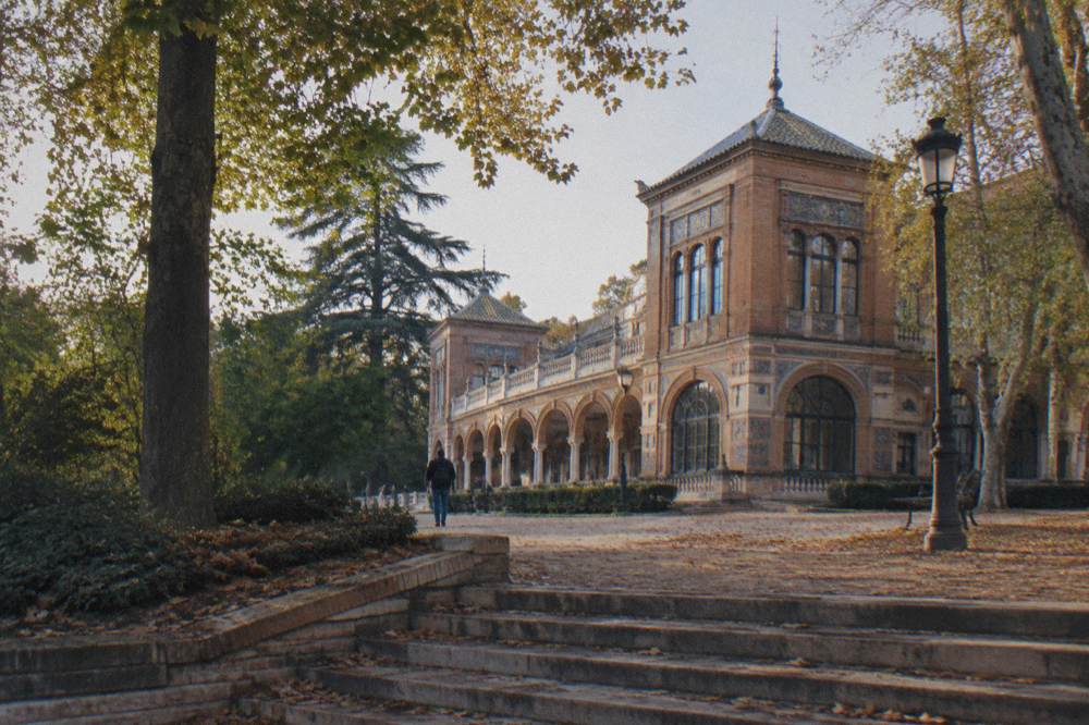 Exterior of the Palacio de Velázquez exhibition pavilion surrounded by trees in Retiro Park