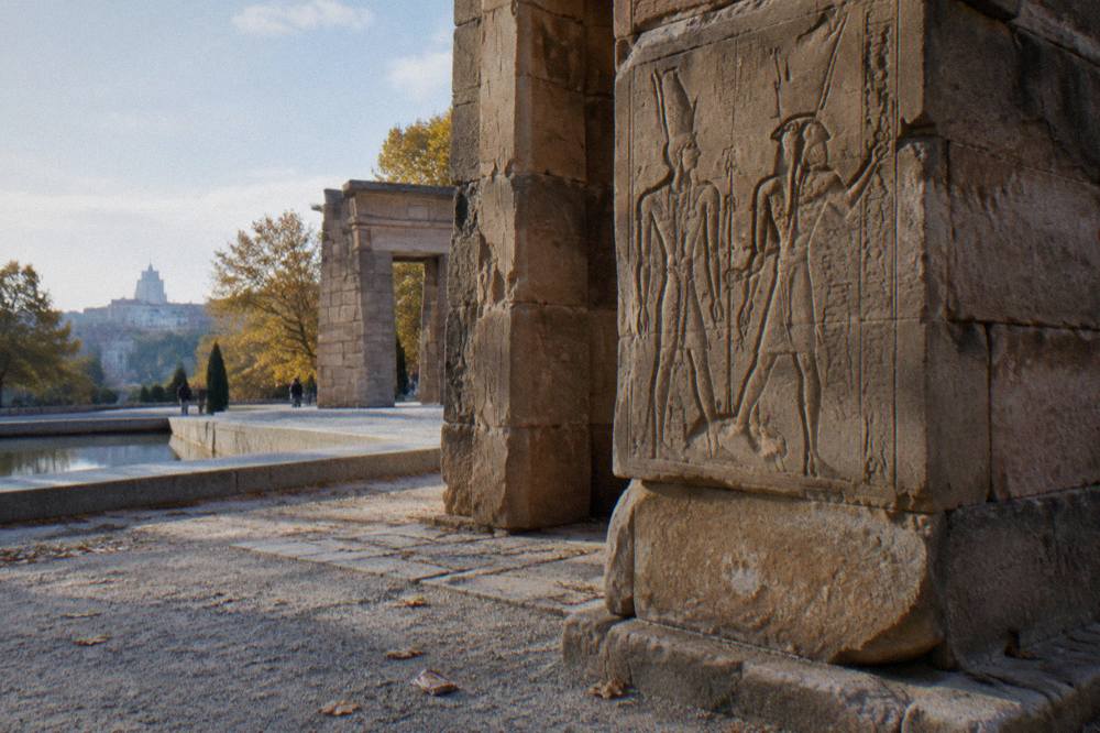 Close view of the stone gateway and carved walls of an ancient Egyptian temple in a park