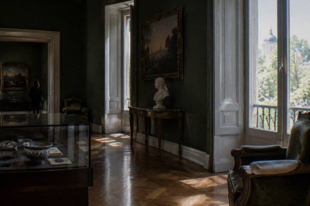 Museum gallery interior with display cases and period rooms