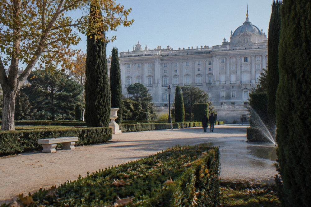 Royal Palace of Madrid seen from the Jardines de Sabatini with formal hedges and gravel paths