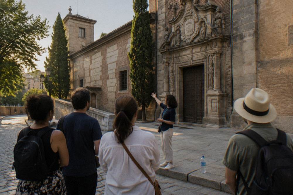 Tour guide speaking to a small group on a Madrid street corner in late afternoon light
