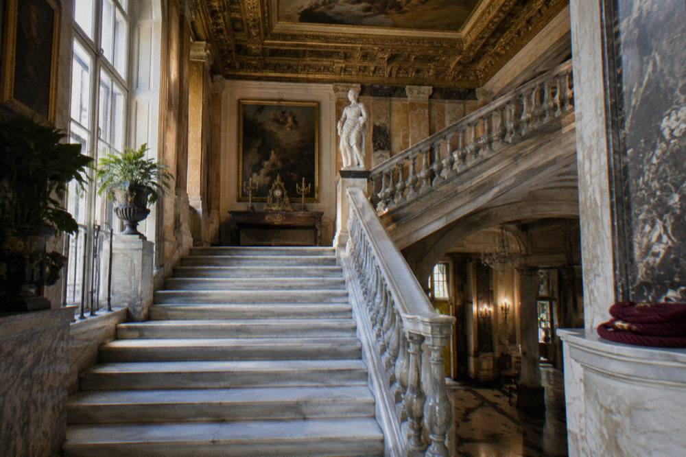 Gilded ceiling and grand staircase inside a historic Madrid palace