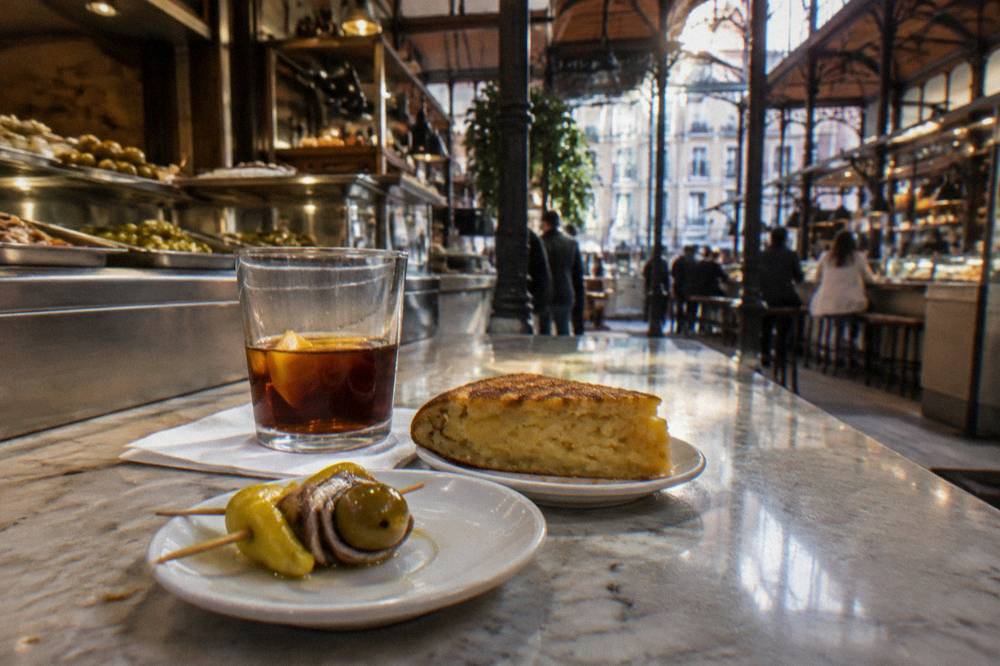 Tapas and drinks displayed on a market stall counter