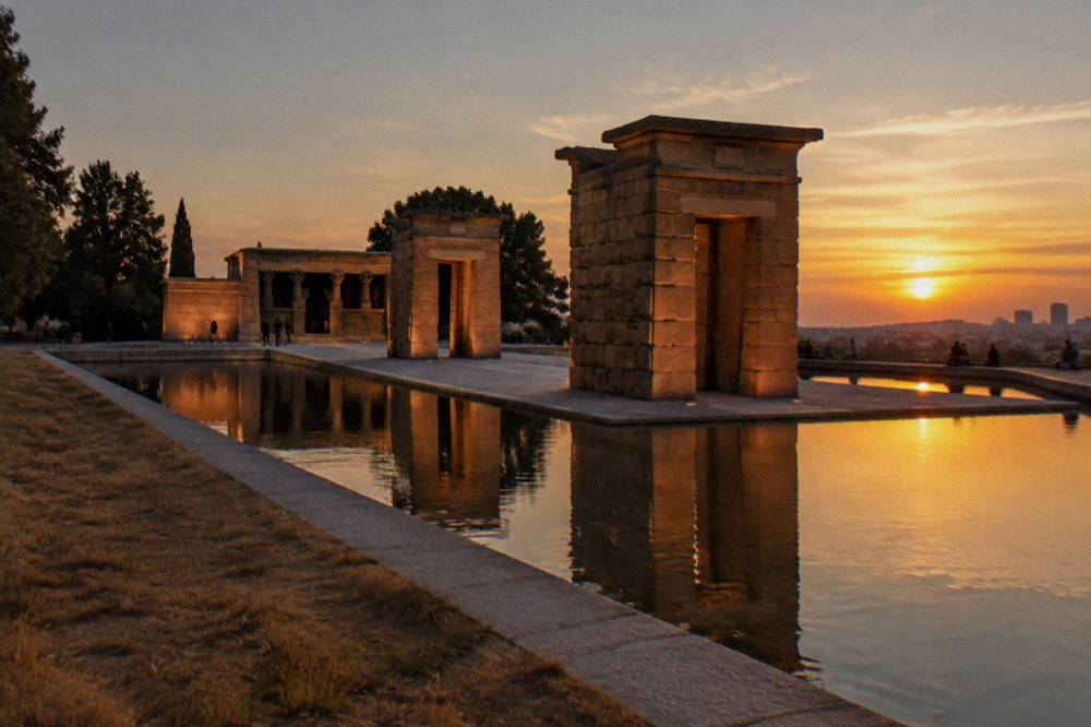 Sunset sky over the Templo de Debod monument and surrounding park in Madrid