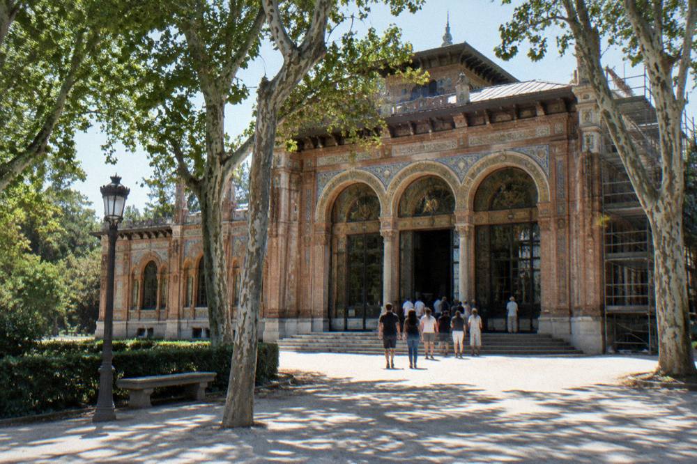Exterior of a Madrid exhibition pavilion with visitors at the entrance during daytime