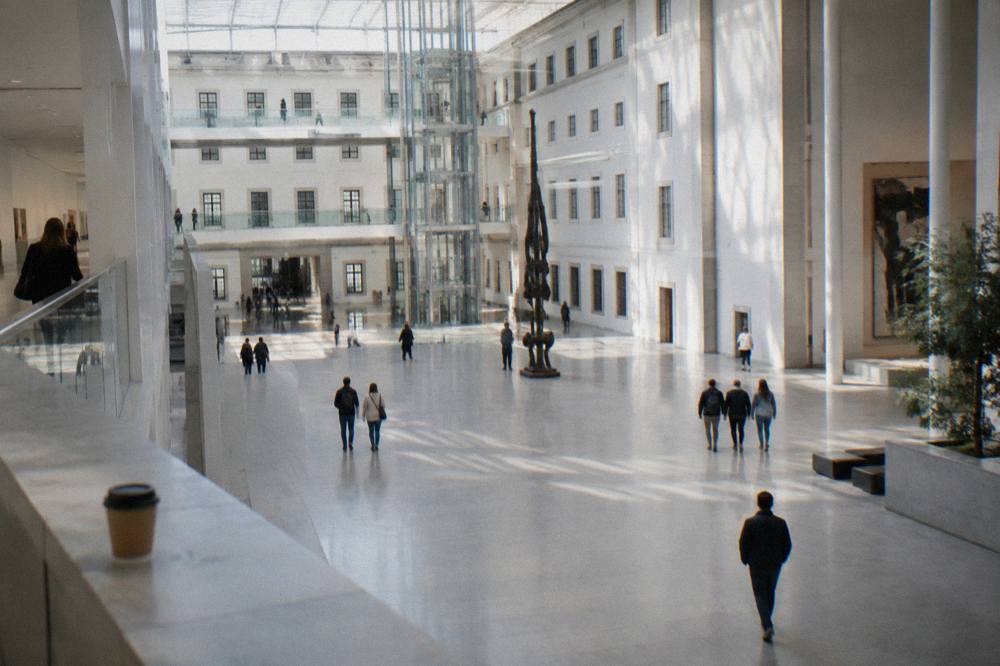 Visitors gathered in the bright central atrium of the Reina Sofía museum