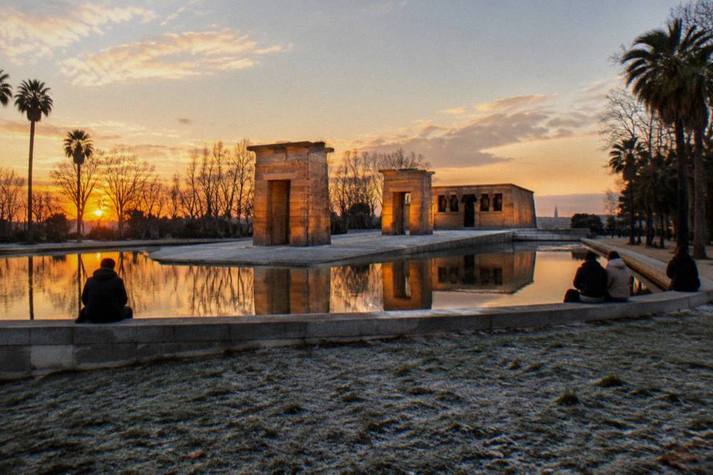 Sunset over an Egyptian temple with a reflecting pool in the foreground